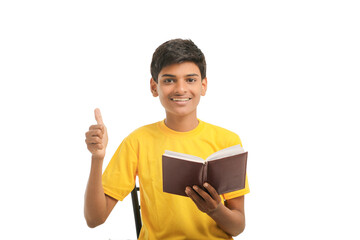 Indian boy with diary on white background.