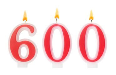 Burning red birthday candles isolated on white background, number 600.