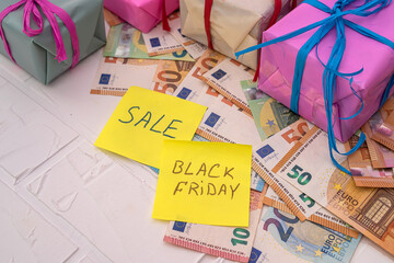 gifts in bright wrappers notebooks and leaflets with the inscriptions black friday  discounts.
