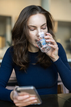 Person drinking water in restaurant