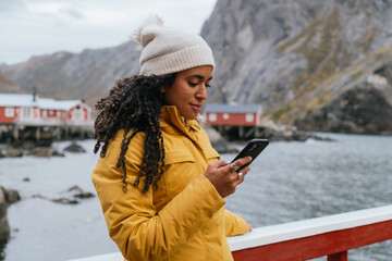 Woman using cellphone in winter