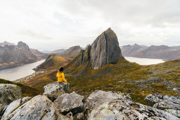 Anonymous hiker admiring rocky cliffs