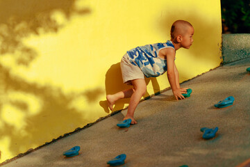 boy practicing rock climbing