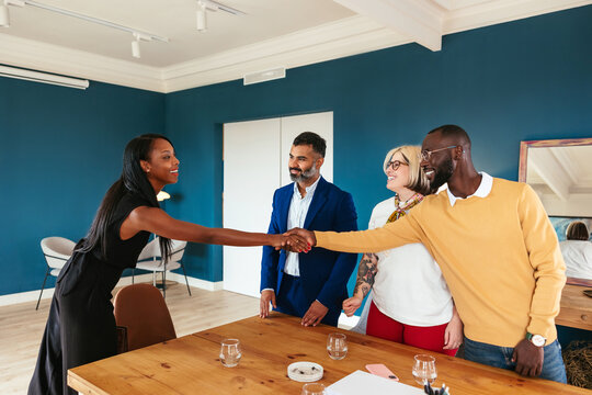 Black lawyer shaking hands with clients