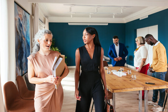 Female notaries talking after meeting