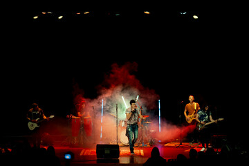 Band performing on stage at music concert.