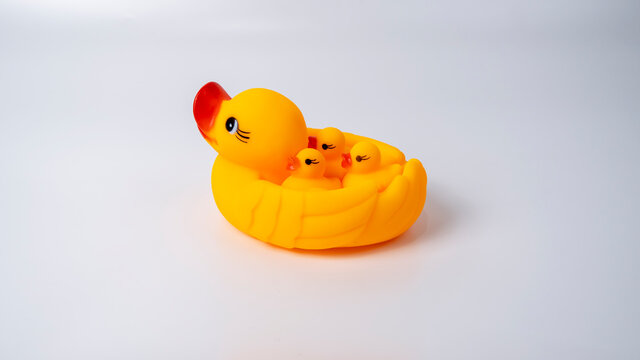 The toys of mother duck and duckling on white background.