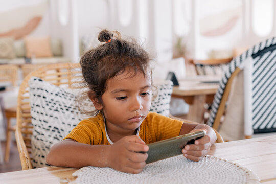 A Child Watching Something on Cell Phone