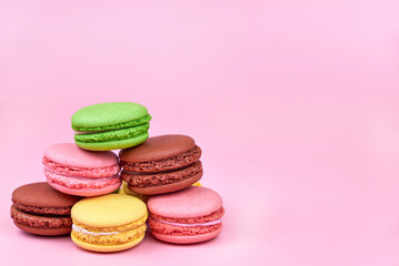 Fototapeta na wymiar Heap of bright cookies on a pink background, copy space.
