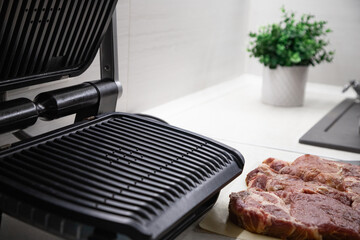 Fresh red meat steak on the grill in the kitchen