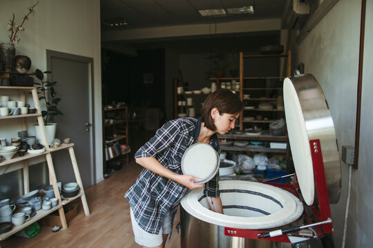 Female artisan makes ceramic products.