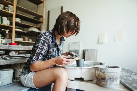 Female artisan makes ceramic products.
