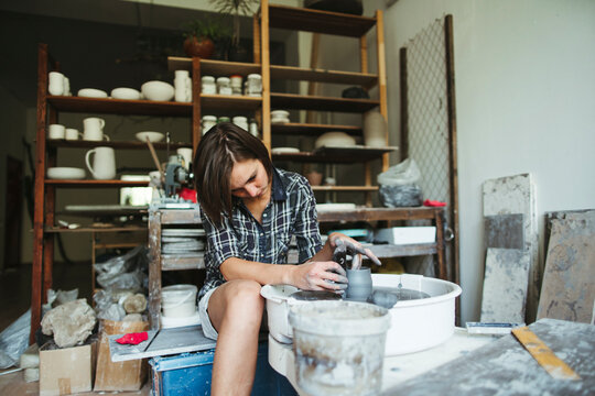Female artisan makes ceramic products.