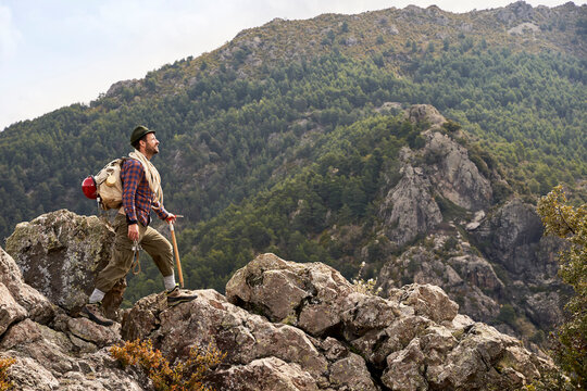 Mid adult male mountaineer walking on mountain
