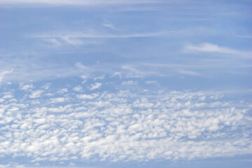 Fototapeta na wymiar Background of white fluffy clouds on the background of soft blue sky.