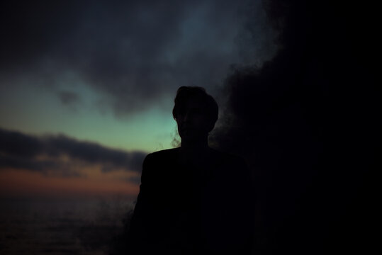 Surreal male silhouette inside smoke