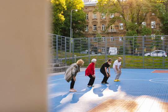 Motivated retiree persons keeping fit 