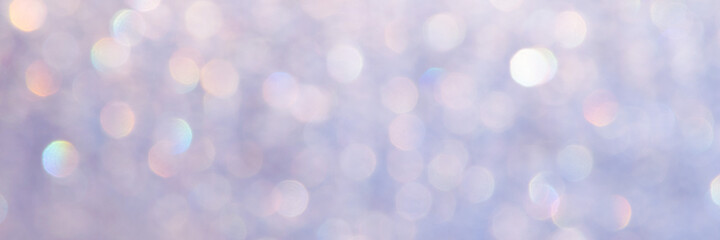 bright glitter background: bokeh effect from many colored lights on frozen glass, toning