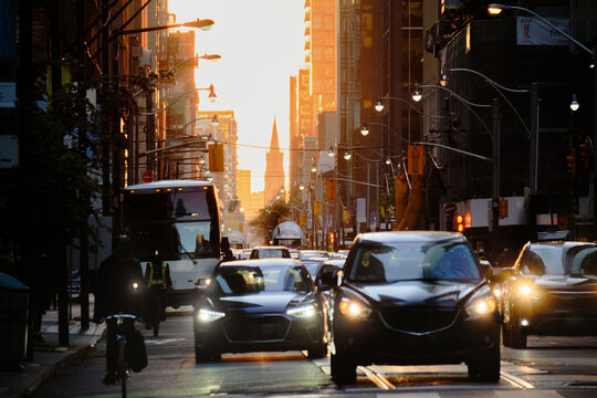 Cars Cross Intersection at Sunset in the City of Toronto, Canada