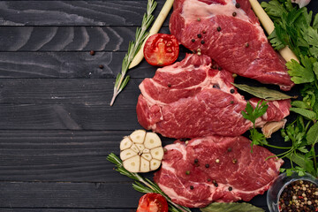 meat on wooden board vegetables and ingredients for cooking wooden background