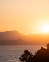 Warm sunrise over mountains and water in Croatia. 