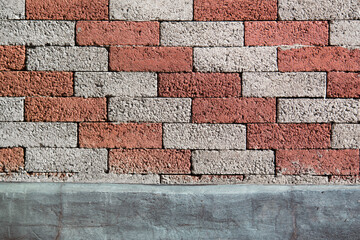 The street wall of red and gray bricks diagonal.