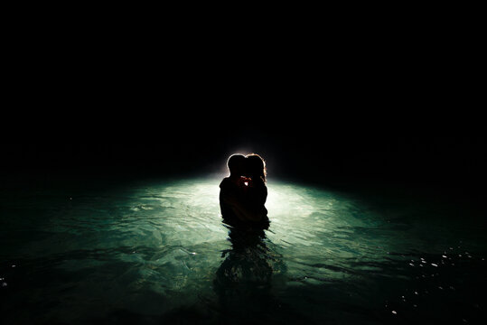 Couple kissing during night swim