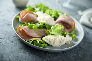 Green salad with mortadella and burrata cheese
