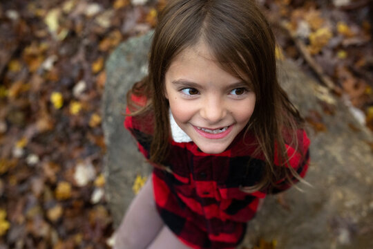 Young girl in red jacket outdoors in fall
