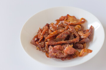 Deep fried sun dried pork is a appetizer in Thai food. It is strip of pork mixed with Thai herb such as coriander seeds and sun-dried until it’s semi dried and fried it fragrant, mellow and delicious.