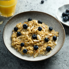Homemade oatmeal porridge with blueberry and almond flakes