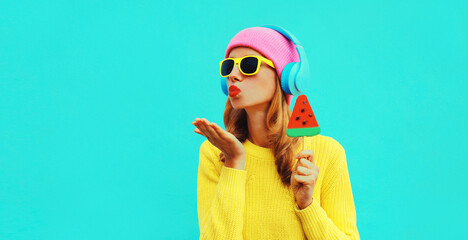 Summer fresh colorful portrait of happy young woman in headphones listening to music with fruit...