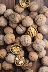 Whole and open walnuts, walnut grain, on a wooden table. Top view