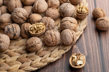 Whole and open walnuts, walnut grain, on a wooden table