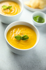 Traditional homemade pumpkin soup with fresh basil