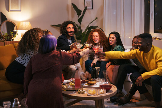 Cheerful diverse people proposing toast