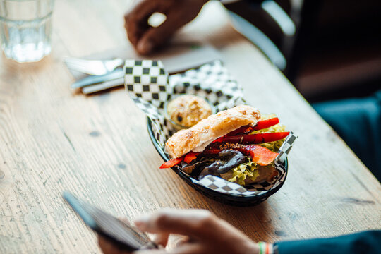 Mature businessman eating lunch in restaurant - Powered by Adobe