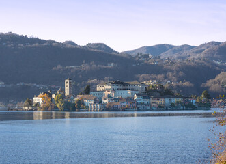 Fototapeta na wymiar San Giulio also called Island of Silence, an oasis of peace in the middle of the Orta lake. Italian lakes, Piedmont, Italy.