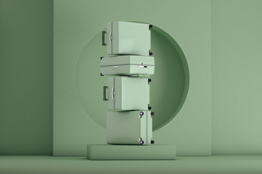 Green suitcases stacked on a stage on green color background