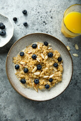 Homemade oatmeal porridge with blueberry and almond flakes