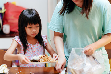Little girl clean up dining table garbage