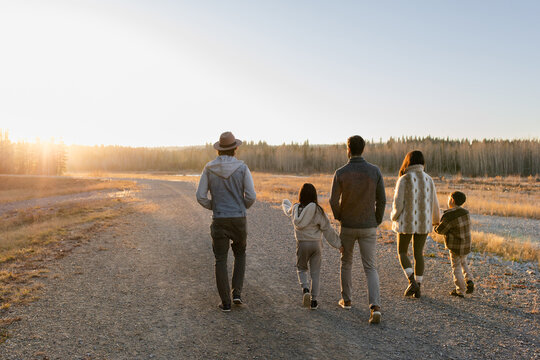 Family Walks Together During Sunset