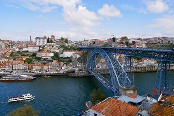 Fototapeta na wymiar Panoramic view of old town and famous Dom Louis I bridge over river Douro. Porto, Portugal.