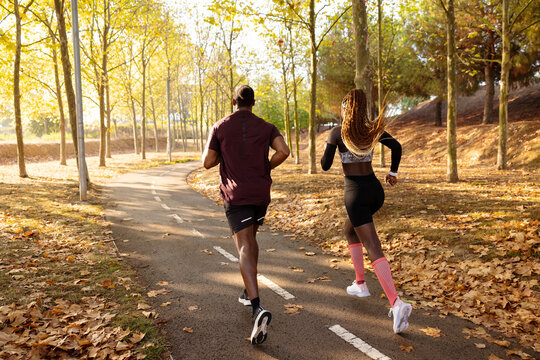 Black athletes running in park