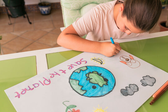 Girl making poster of environmental issues at home
