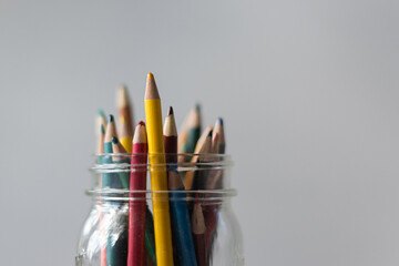 Colored pencils in glass jar