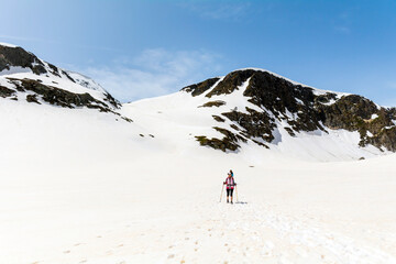 Fototapeta na wymiar Woman Hiking in the High Snowy Mountain .Winter Vacation in Bulgaria ,Seven Rila Lakes 