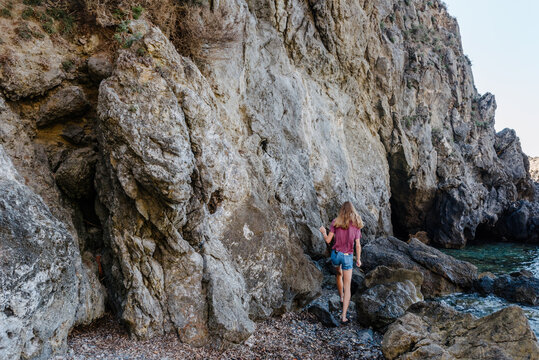 Teenage girl exploring a cave