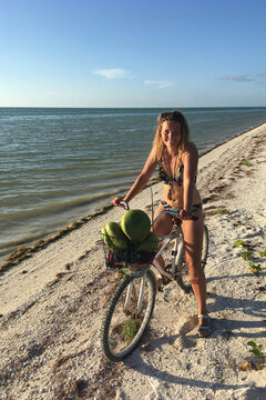 happy Woman Riding A Bicycle at the beach