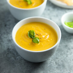 Traditional homemade pumpkin soup with fresh basil